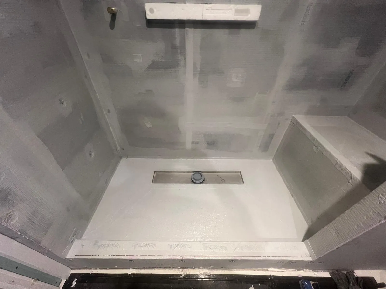 Shower area boarded and waterproofed with a linear drain before tiling